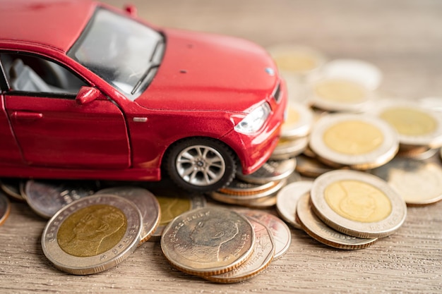 BANGKOK THAILAND FEBRUARY 12 2023 Car on coins background Car loan Finance saving money insurance and leasing time concepts