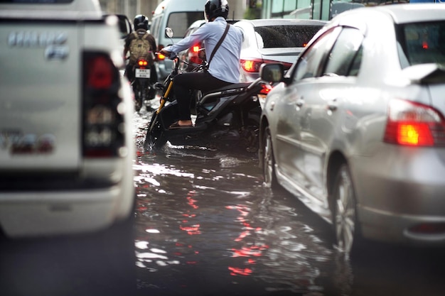 Bangkok Thailand May 16 2019Flood on public road and motorcycles and minitruck in traffic jam