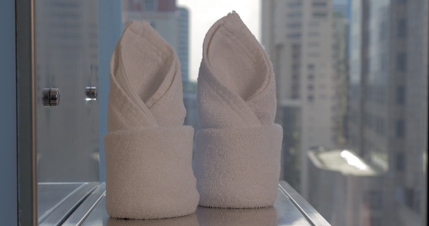 In bangkok thailand in room on a shelf with a mirror placed two folded towels