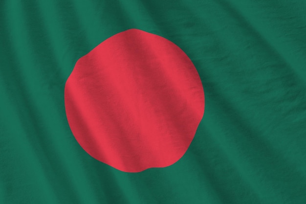 Bangladesh flag with big folds waving close up under the studio light indoors The official symbols and colors in banner