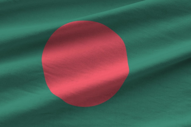 Bangladesh flag with big folds waving close up under the studio light indoors The official symbols and colors in banner