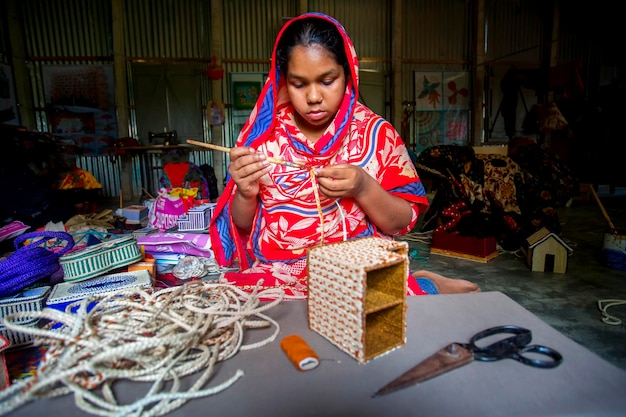 Bangladesh May 13 2018 A young crafts maker is making a showpiece from the fibers of a banana tree at Madhupur Tangail