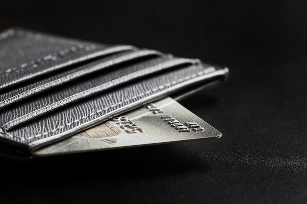 Bank credit card in the wallet on dark background