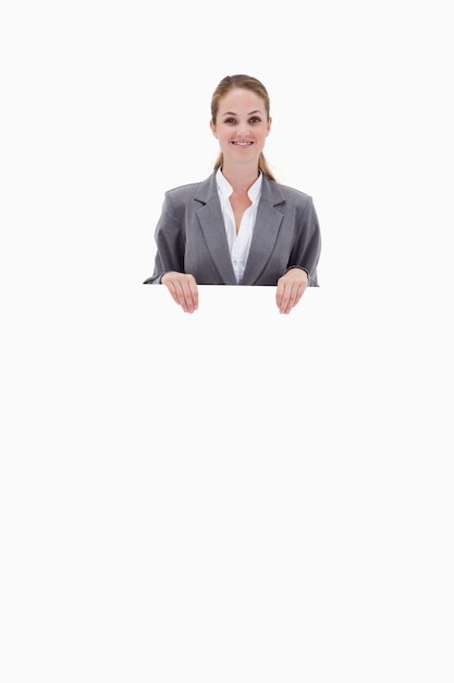 Bank employee holding blank sign in her hands