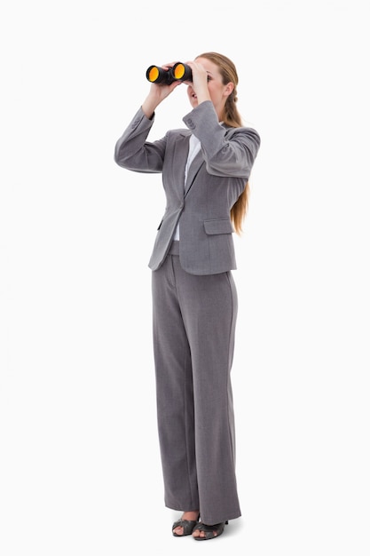 Bank employee looking through binoculars