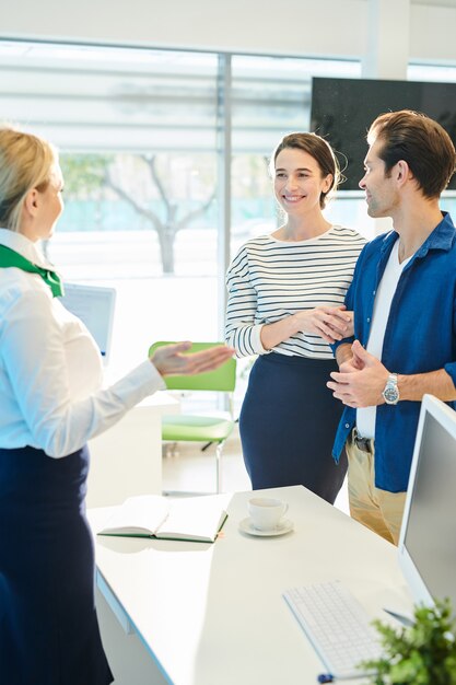 Bank representative welcoming young couple