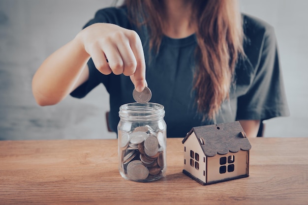 A bank with coins and a house on the table