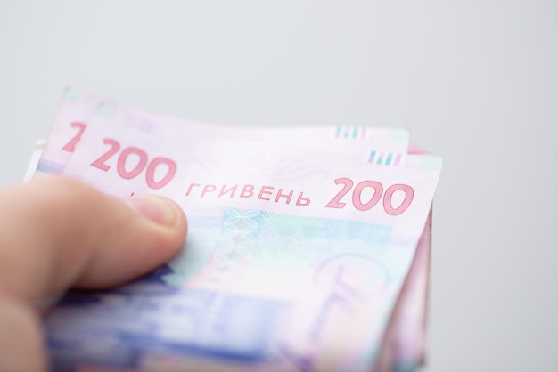 Bankbiljetten van 200 hryvnia's in iemands hand close-up