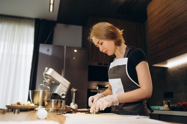 Banketbakker banketbakker jonge blanke vrouw met keukenkom op keukentafel Taarten dessert maken