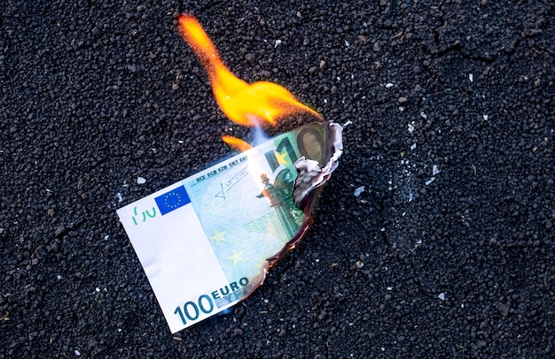 The banknote burns during a fire. Crisis concept.