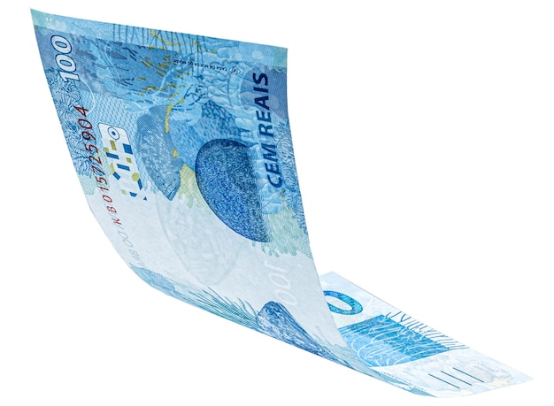 Banknote of one hundred reais from brazil falling on isolated white background