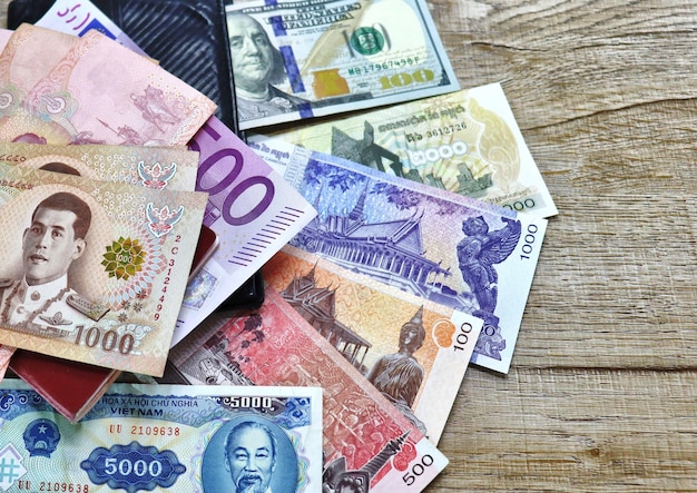 banknotes of different countries and colors on the table
