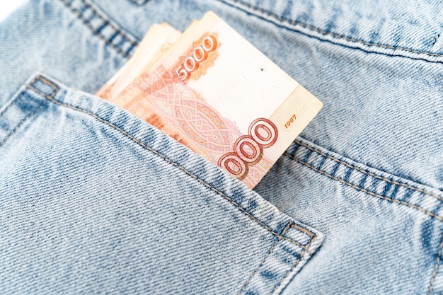 Banknotes in the pocket of blue jeans cash turnover russian 5000 banknote