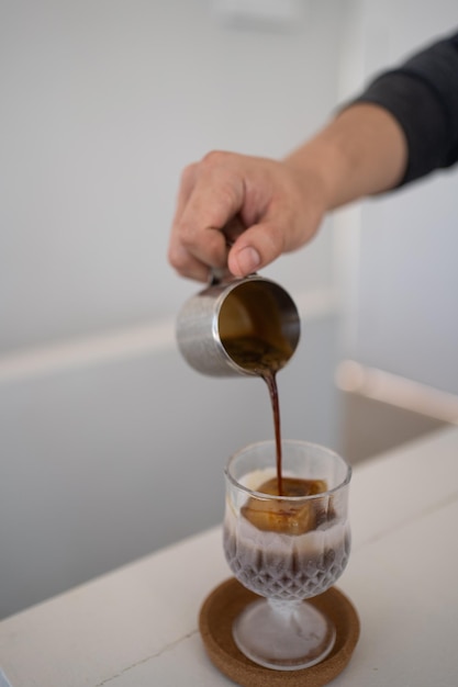 Banner of Asian Barista tamping the portafilter and preparing cup of coffee