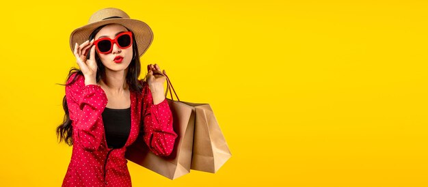 Banner of asian trendy shopaholic woman excited about new purchases or sales holding shopping bags a