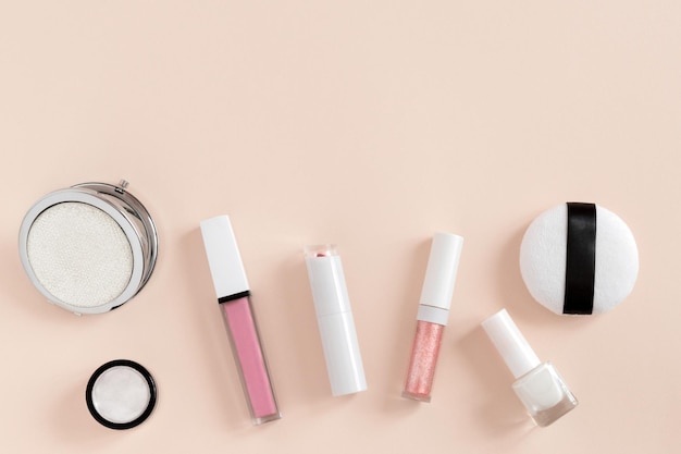 Banner background with flatlay cosmetics on delicate pink background Makeup accessories lipstick top view in pastel colors copy space