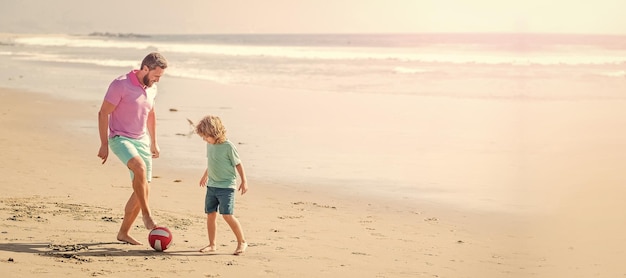 Banner of father and son play soccer or football on beach weekend family day dad and child having fun outside childhood and parenting