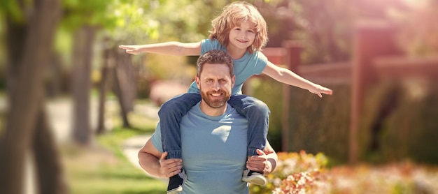 Banner of father and son walk cheerful father and son have fun in park family value childhood and parenthood