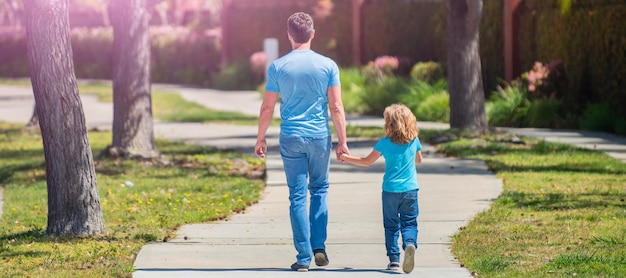 Banner of father and son walk in park back view family value childhood and parenthood