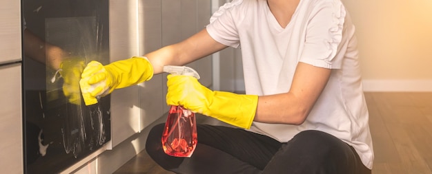 Banner female person cleaning kitchen and oven, housemaid concept background photo