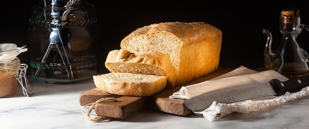 Banner of Fresh homemade Toast bread on the kitchen table dark background