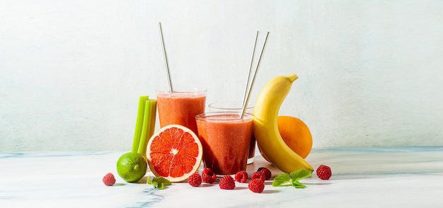 Banner of fresh smoothie juice in glasses with metal tubes on the table and ingredients. healthly food