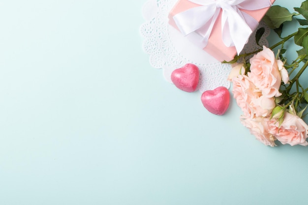 A banner layout with a gift roses and a knitted heart on a light blue background