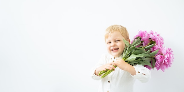 Banner. little blonde boy with big bouquet of pink peonies