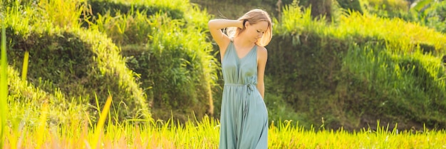 Banner long format beautiful young woman walk at typical asian hillside with rice farming mountain