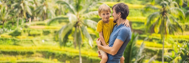 Banner long format dad and son travelers on beautiful rice terraces against the background of famous