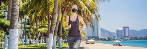 Photo banner long format woman runner wearing medical mask running in the park coronavirus pandemic covid