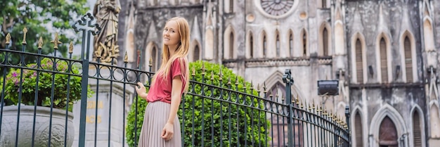 Photo banner long format young woman tourist on background of st josephs cathedral in hanoi vietnam reopens after coronavirus quarantine covid 19