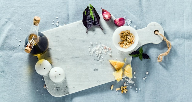 Photo banner of marble cutting board and spices on a linen blue tablecloth