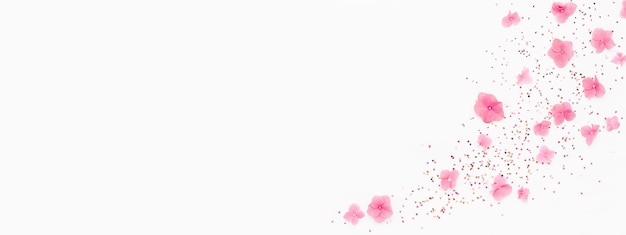 Banner. Pink flowers, glitter confetti splash on white