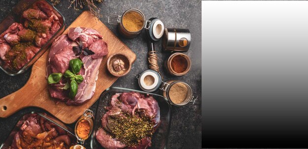 Banner of raw meat with herbs spices sauces on concrete background Top view flat lay