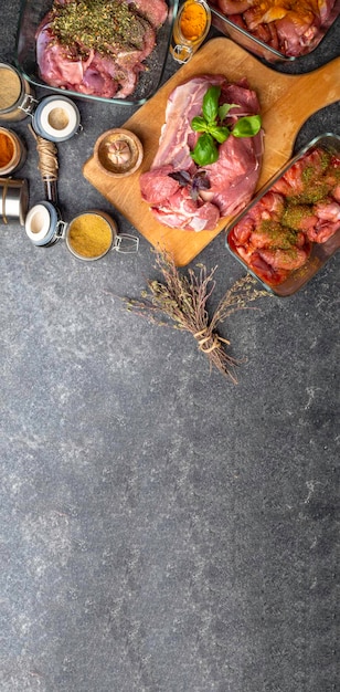 Banner of raw meat with herbs spices sauces on concrete background Top view flat lay