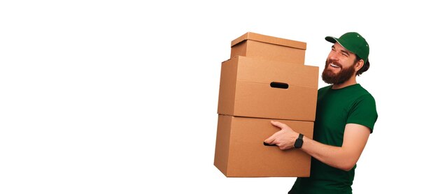 Banner shot of a cheerful strong delivery man holding some boxes while working