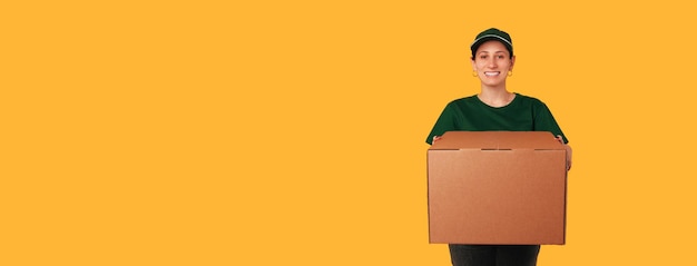 Banner size photo with copy space of a delivery woman holding a big box