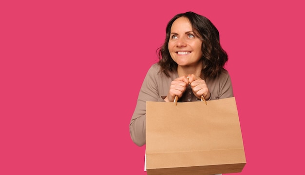 Banner size shot of a cheerful woman holding a shopping bag with copy space