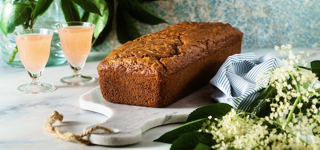 Banner di torta estiva dolce su un tavolo con fiori e un drink in bicchieri dessert per il brunch o la colazione del mattino