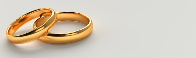 Photo banner of two wedding gold rings lie on each other with blank space background