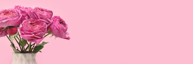 Banner with bouquet of rose flowers in front of pink background