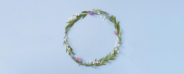 Banner with floral round frame with copy space on a blue background Summer or spring nature minimalistic background