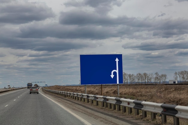 Banner with traffic directions on the side of a country\
road