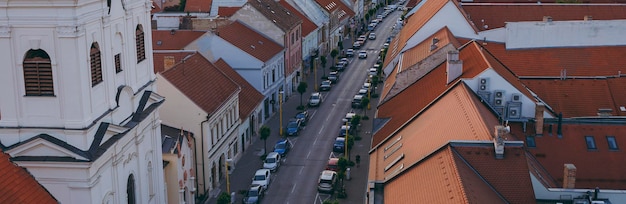 Banner with a view of rooftops and cars