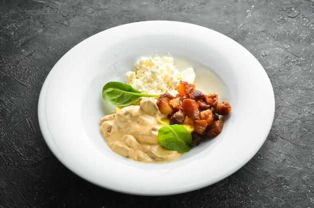 Banosh met champignons, spek en brynza-kaas op een bord Hongaarse traditionele keuken Bovenaanzicht