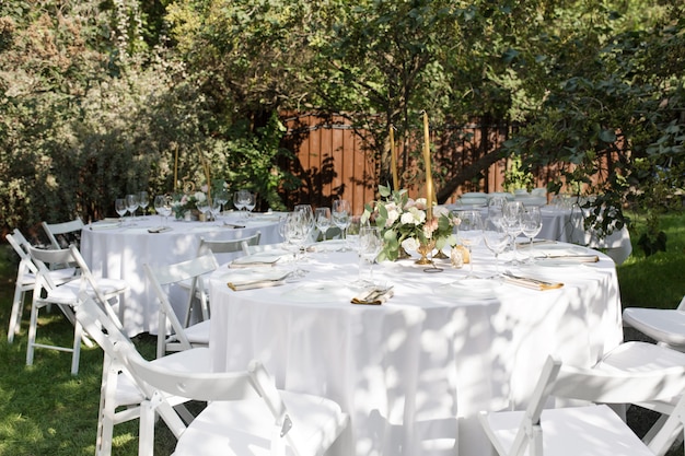 Banquet table for guests outdoors with a view of green nature