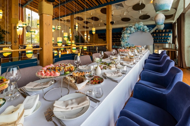 Banquet table setting, cold snacks and rolls on the table in a restaurant