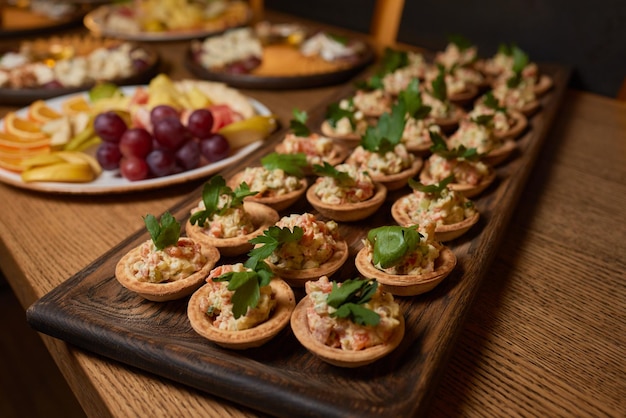 Banquet table with snacks food on plates festive table corporate food