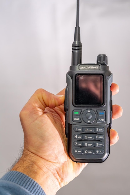 Baofeng BF21 portable amateur radio held in the hand of a white person